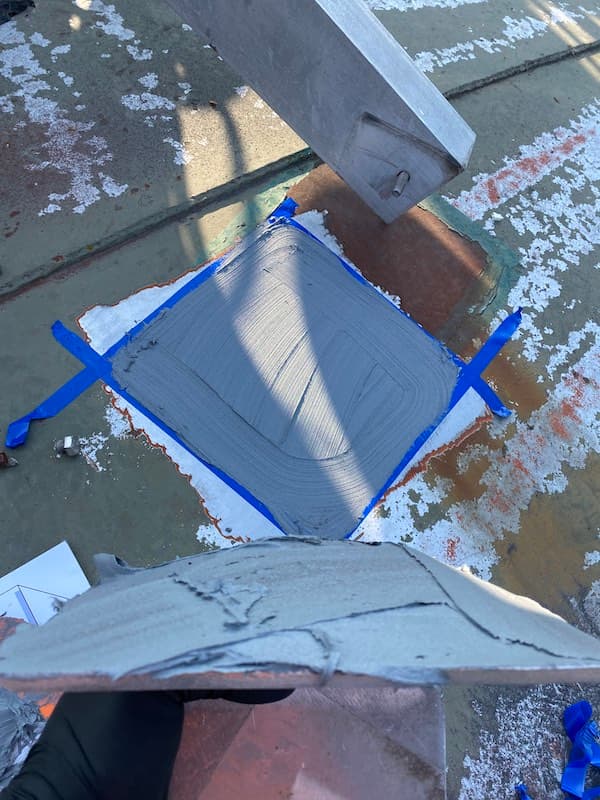 Antenna mounting plate positioned on water tank with Belzona cold bond