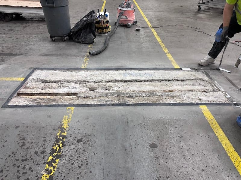 Damaged warehouse floor joint from steel wheel cart traffic