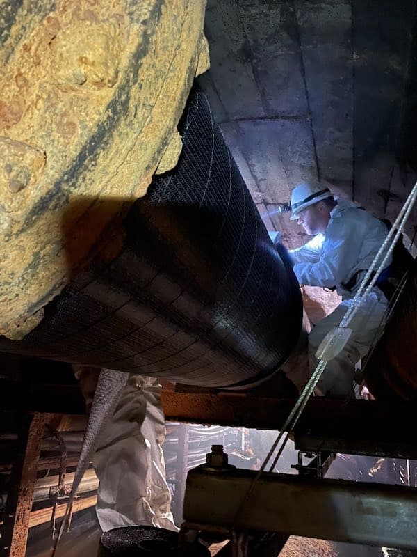 SuperWrap II composite being applied to pipe